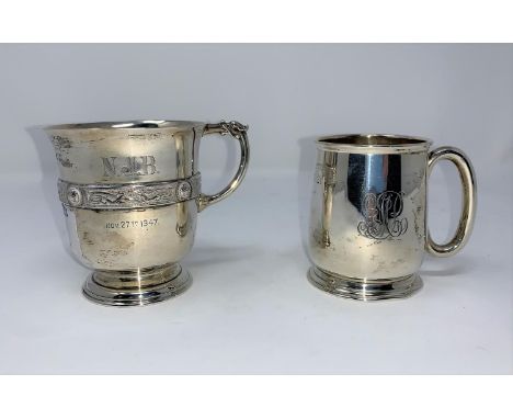 A silver christening mug with Celtic band, monogrammed, London 1946; a similar plain mug, Birmingham 1921 