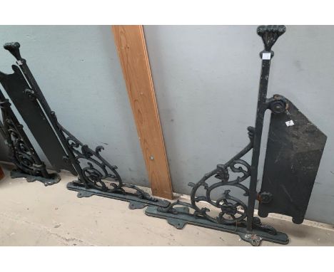 A large pair of ornate Victorian cast iron wall brackets and similar bracket 