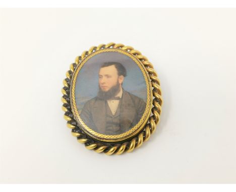 A gilt brooch depicting half portrait of man 