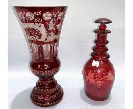 A 19th century Bohemian ruby overlaid and cut back vase, height 17cm; a similar decanter 