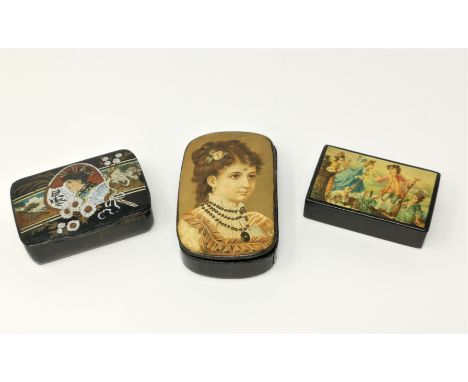 A late 19th century lacquer snuff box with chromolitho genre scene to the lid, 9 cm; 2 others 