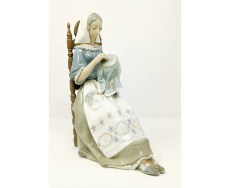 A Lladro figure of woman sewing in high back chairC RepIn good condition with no obvious damage repair or restoration 