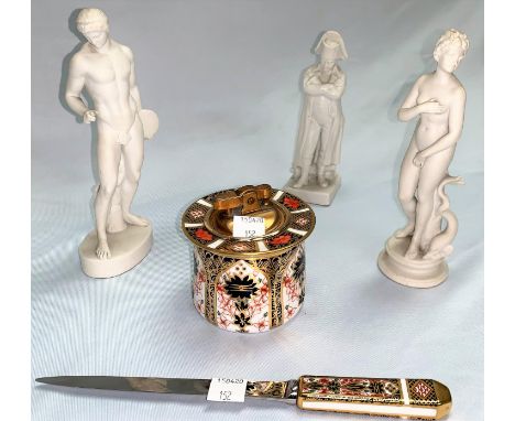 Three white bisque figures; a Royal Crown Derby Imari pattern table lighter (hairline crack to base) and letter opener C RepC