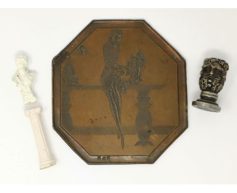 A cast and bronzed metal printing plate depicting a stylish 1920's woman, 18 cm high; a seal with multi-mask handle, 52 mm; a