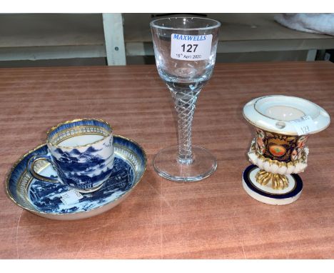 An 18th century style air twist wine; an early 19th century English porcelain coffee cup and saucer in blue and white; an ear