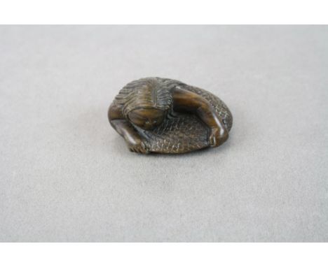 A vintage signed carved chinese netsuke of an oriental mermaid.
