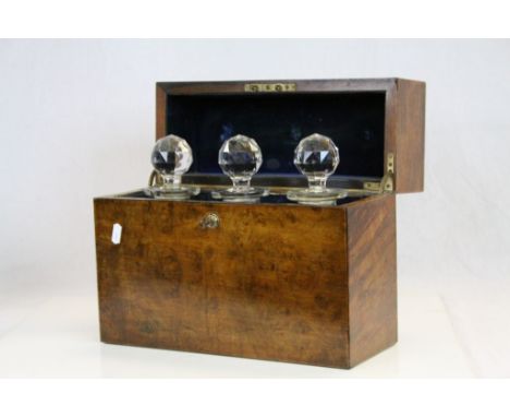Walnut veneer Three bottle Tantalus Box with spring loaded key &amp; three Cut Glass Decanters, the Velvet lined interior bea