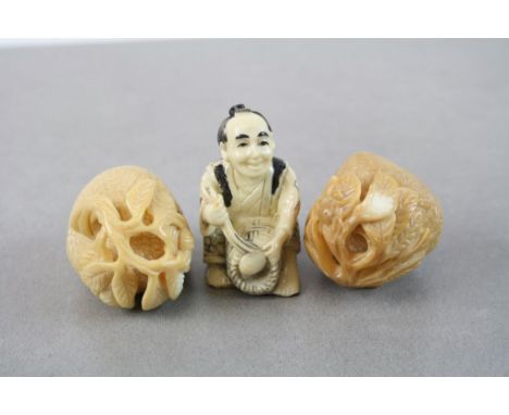 Two Oriental carvings of fruit plus a resin netsuke type figure of a basket maker