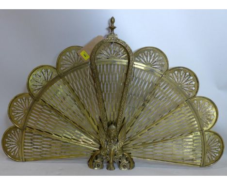 An early 20th century pierced brass peacock firescreen, H.64 W.94cm (fully extended) 
