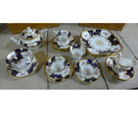 A late 19th / early 20th century Coalport Batwing china tea service, hand-painted with floral decoration and gilt detailing, 