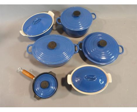 Collection of Vintage blue Le Creuset kitchenware. Three casseroles in varying sizes, a small lidded saucepan and two oval ca