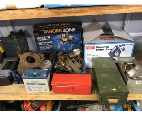 A quantity of assorted on one shelf, to include brass cannons and a router table etc.