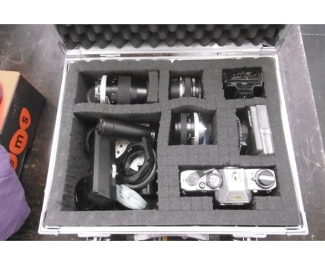 A CASED OLYMPUS SLR CAMERA WITH EXTRA LENSES