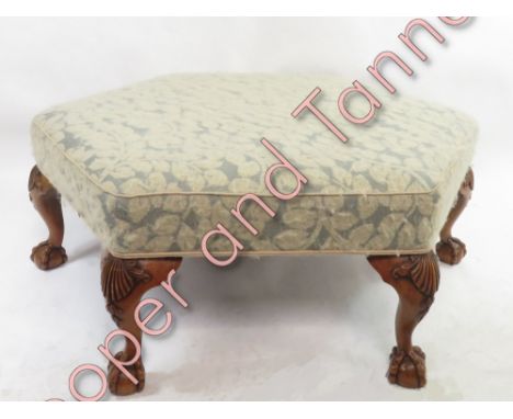A modern hexagonal stool, raised on walnut ball and claw feet, 39cm high, 93cm diameter