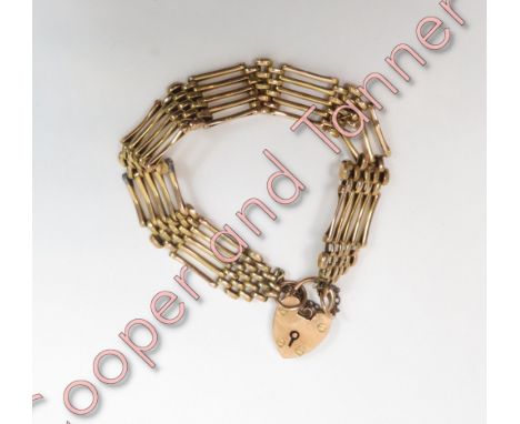 A bracelet, stamped '15ct', of five bar gate links to a padlock clasp, 16.5 g gross