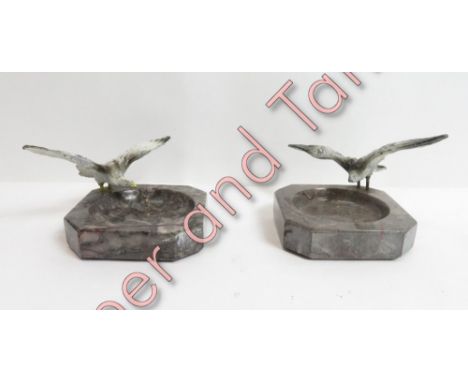 Two marble ashtrays each with a spelter model of a bird
