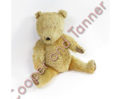 A vintage straw filled teddy bear
