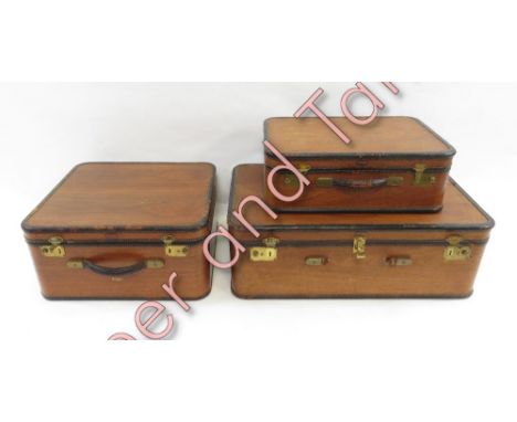 A set of three graduated laminate wood vintage Amelia Earhart suitcases