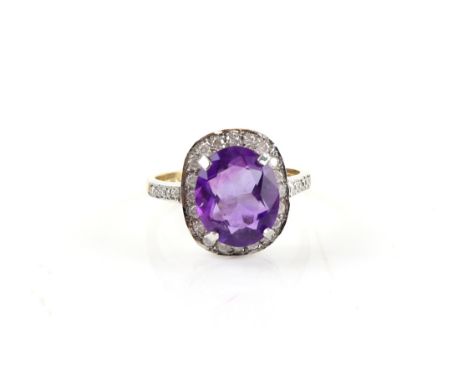 Dress ring with large central amethyst within a border of diamonds, 9 ct gold, ring size N1/2 .    