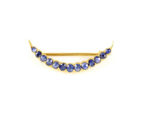 Vintage sapphire crescent brooch, thirteen oval cut sapphires, estimated total weight 0.98 carats, mount testing as 18 ct, 3.