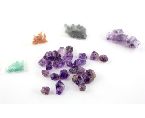 A group of specimen gem stones, including emerald and ,  sapphire crystals and a quantity of amethyst .    