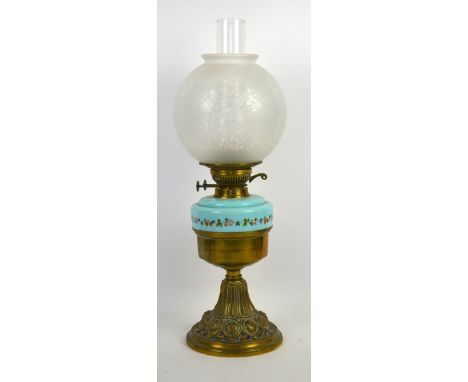 Victorian brass based oil lamp, blue glass rim with enamelled flowers and foliage, and a globe form etched glass shade.    