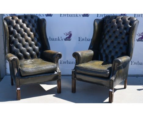 Pair of 18th century green leather button back arm chairs.    