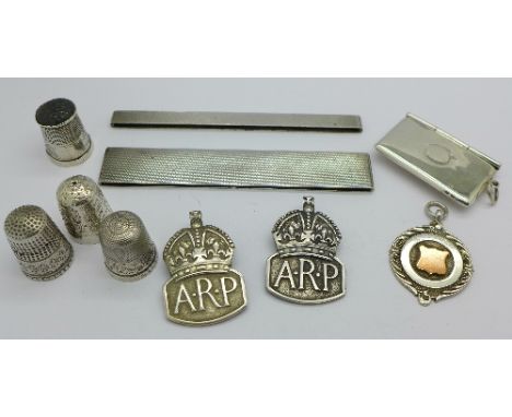 Two silver ARP badges, London 1938, four silver thimbles including one by Charles Horner, a 925 silver stamp case, a silver f