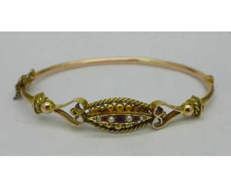 A 9ct gold, ruby and pearl bangle, 6.4g