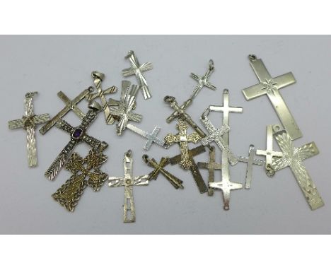 Twenty-three silver cross pendants