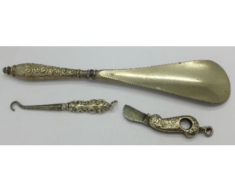 A silver cigar cutter/penknife and a silver handled button hook and shoe horn