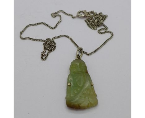 A jade pendant on a silver chain