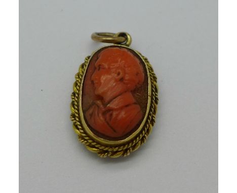 A 19th Century yellow metal memorial pendant with carved coral portrait, width 12mm