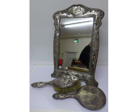 A large silver framed mirror and a silver backed mirror and brush, a/f, height of mirror 39cm