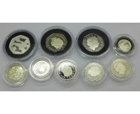 Five £1 commemorative coins, a 1/10th oz. silver 20p coin and three 50p proof coins