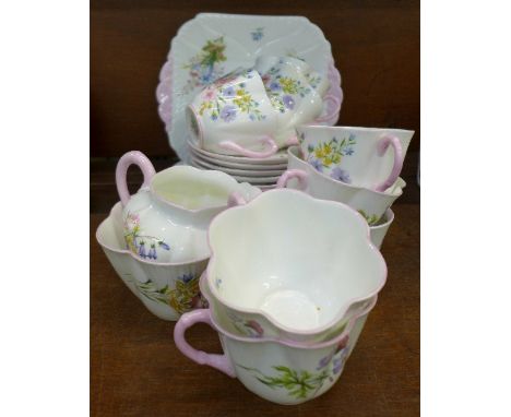 Eight Shelley Wild Flowers cups and saucers, four tea plates, cake plate, creamer and sugar bowl