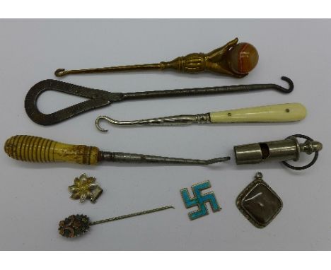Four button hooks, one with brass handle set with ball shaped agate and one White Heather advertising, a whistle, two pendant