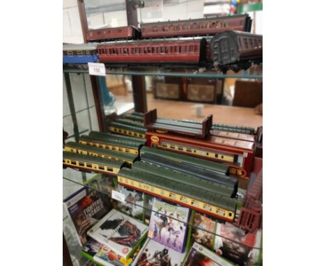 Shelf of 00 gauge train carriages. 