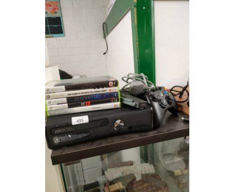 Xbox 360 console with controller and power supply and games . 