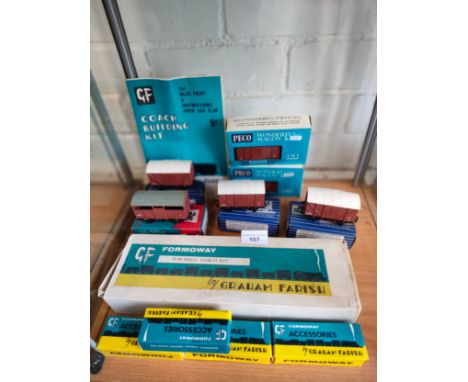 Shelf of 00 gauge wagons , Graham farish suburban building kit etc .