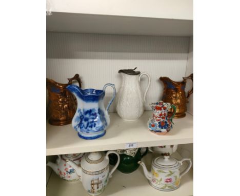 Shelf of Victorian graduated jugs etc . 