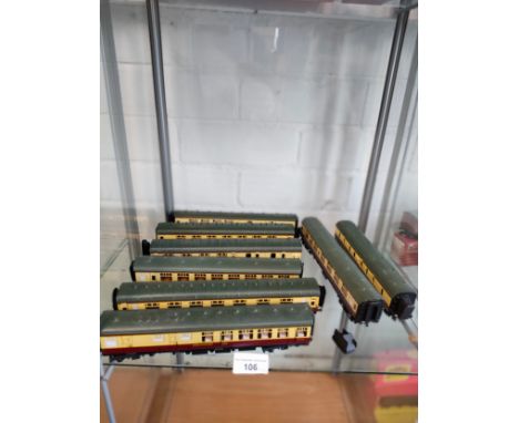 Shelf of 00 gauge coaches etc .