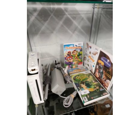 Nintendo Wii console with controller and games . 