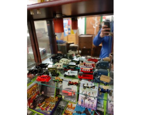 Shelf of collectable van and car vehicles . 