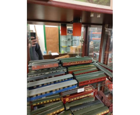 Shelf of train carriages includes oo gauge . 