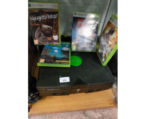 Xbox original console with power supply together with Xbox 360 games . 
