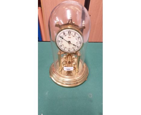 Vintage brass clock with enamel face with 4 ball revolving pendulum. Working order . 