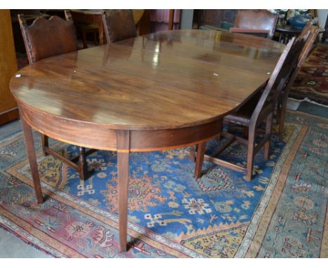A 19th century mahogany demi-lune dining table, the pair of independent gate-leg ends united by a pair of wide inset leaves, 