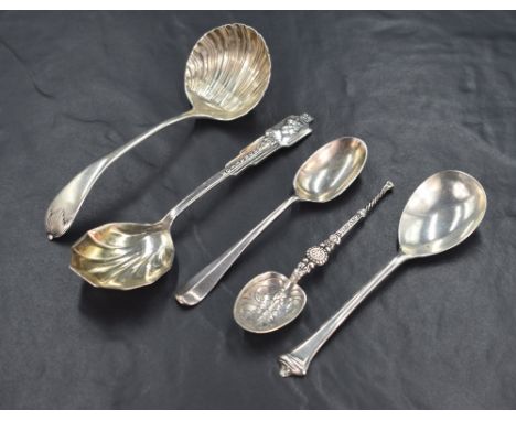 A group of four silver spoons, including an Annointing spoon replica, a sauce ladle and a commemorative spoon for the coronat