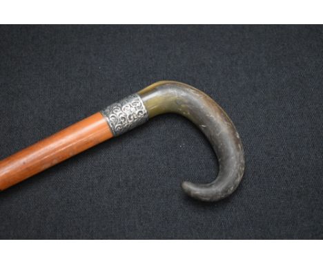 A Victorian silver mounted walking stick, the wooden cane with silver ferrule and curved horn handle, having decorative engra